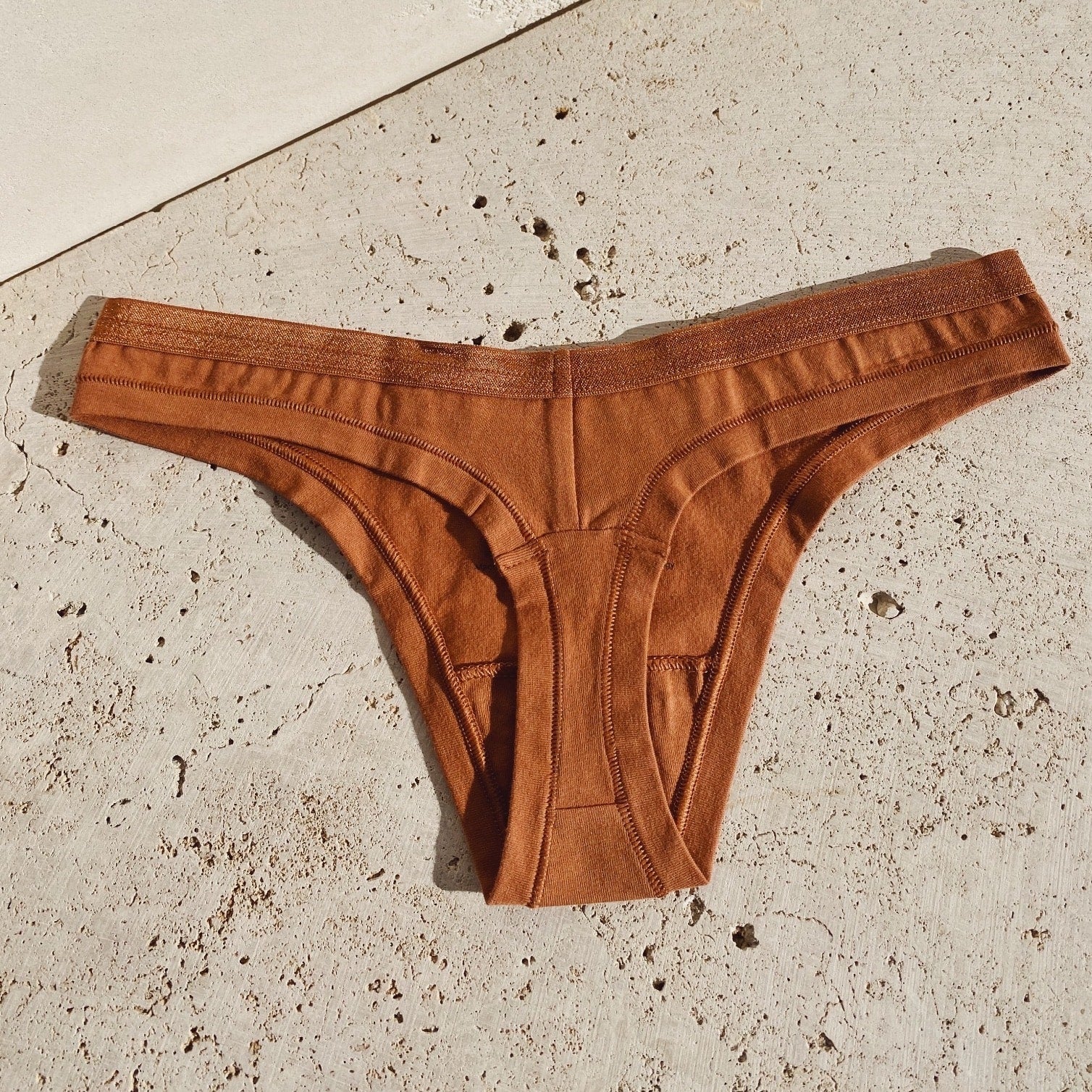 https://thewellrefill.com/cdn/shop/products/knickey-thong-underwear-2-min_2048x2048.jpg?v=1653436677
